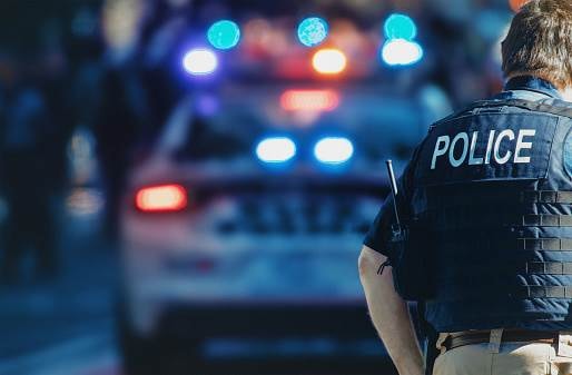 Police support services officer with emergency vehicle lights